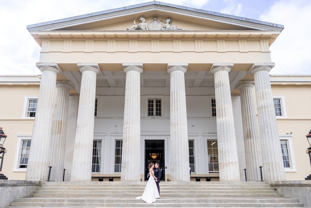 Bride and groom on the steps of Sandhurst Miltary Wedding