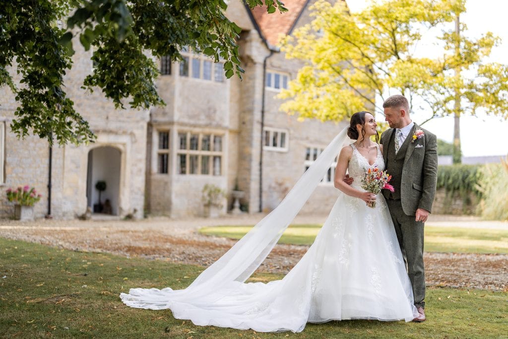 Bride and Groom in front of Manor Farm Park Wedding Venue, Oxfordshire